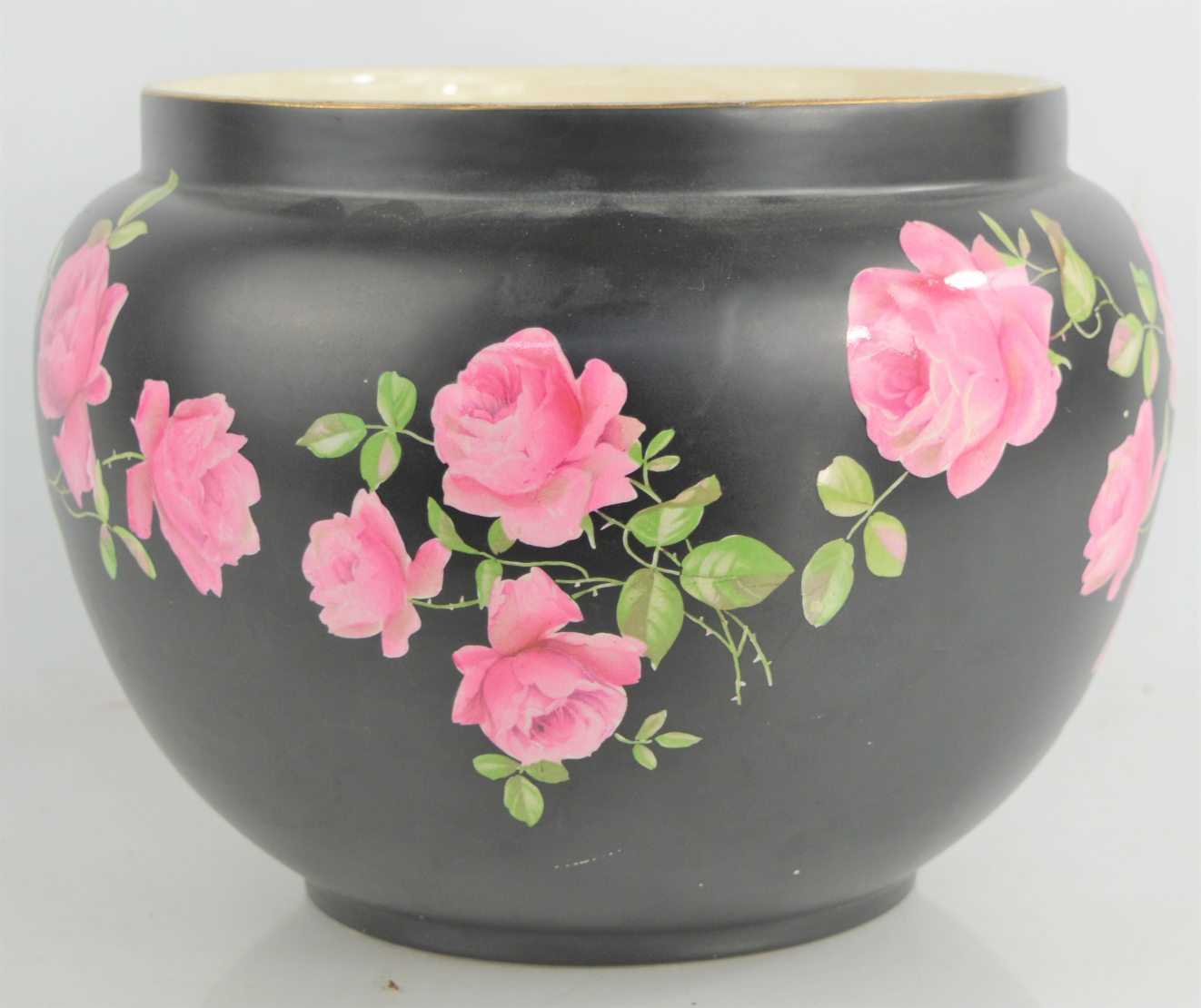 Lot 106 - A Crown Ducal jardinière decorated with pink...