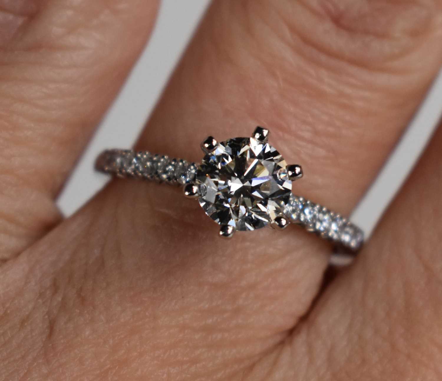 Lot 11 - A platinum and diamond solitaire ring, the...
