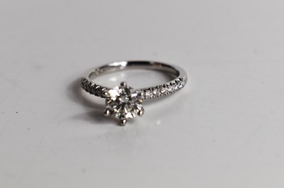 Lot 11 - A platinum and diamond solitaire ring, the...