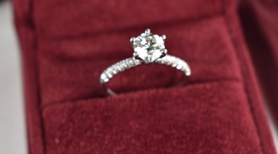 Lot 11 - A platinum and diamond solitaire ring, the...