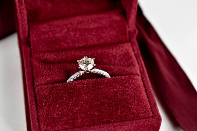 Lot 11 - A platinum and diamond solitaire ring, the...