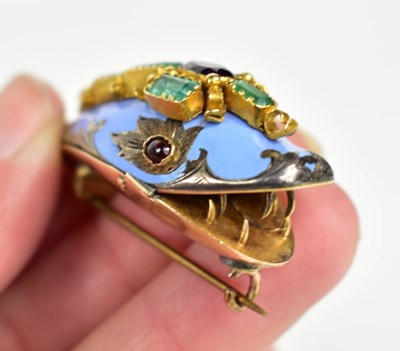 Lot 27 - A gold, blue enamel, emerald and ruby brooch...