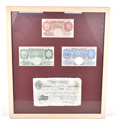 Lot 151 - A group of four framed bank notes to include a...