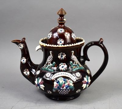 Lot 289 - A 19th century Bargeware pottery teapot of...