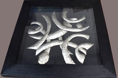 Lot 509 - A framed and glazed welded aluminium abstract...
