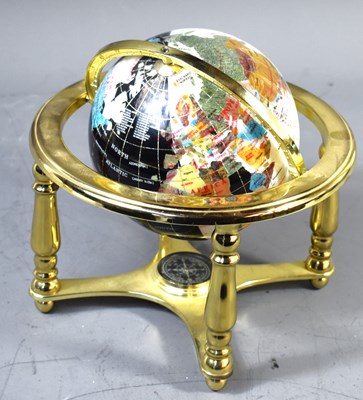 Lot 558 - A semi-precious gemstone inlaid world globe on...