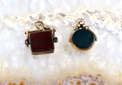 Lot 90 - Two 9ct gold swivel fobs, one set with red...