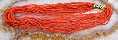 Lot 103 - A coral multi strand beaded necklace with an...