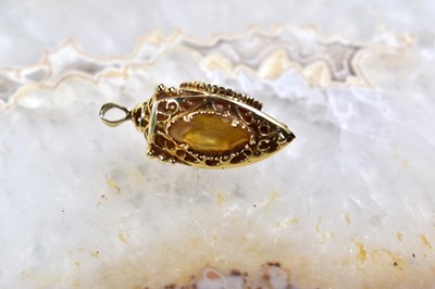 Lot 104 - A 9ct gold gem set three sided pendant, with...