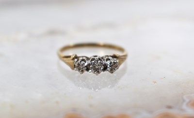 Lot 44 - A 9ct gold and three stone diamond ring, size...