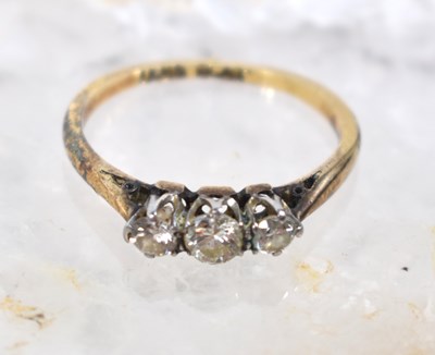 Lot 84 - A gold and three stone diamond ring, size L, 2....