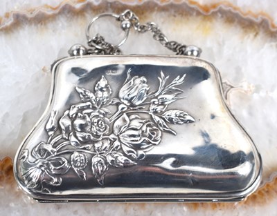 Lot 60 - An Edwardian silver purse with embossed floral...