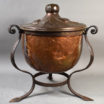 Lot 357 - An Arts and Crafts hammered copper coal bucket...