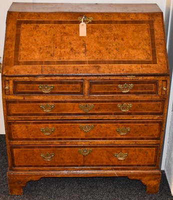 Lot 640 - A George I burr walnut bureau with crossbanded...