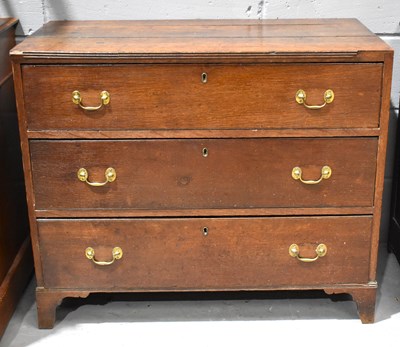 Lot 606 - A Georgian oak chest of three graduated...