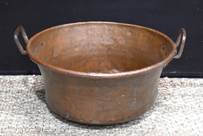 Lot 403 - An antique copper cauldron / boiler with twin...