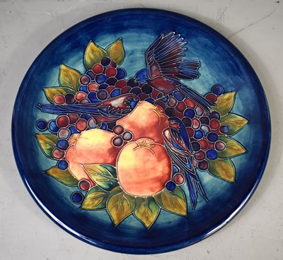 Lot 317 - A Moorcroft charger with Blue Finches design,...