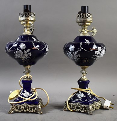 Lot 246 - A pair of blue porcelain oil lamps with white...