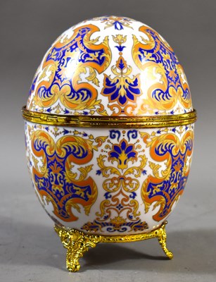 Lot 247 - A porcelain egg hinged trinket box in the...