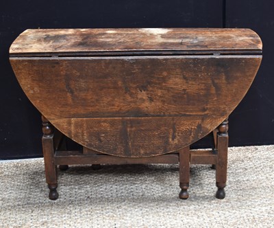 Lot 603 - An 18th century oak drop leaf gateleg table,...