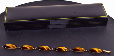 Lot 99 - A 9ct gold and tigers eye bracelet, 21cm in...