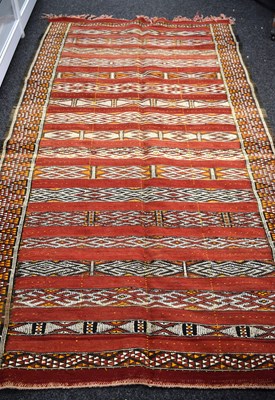 Lot 598 - A Middle Eastern handwoven wool kilim rug, red...