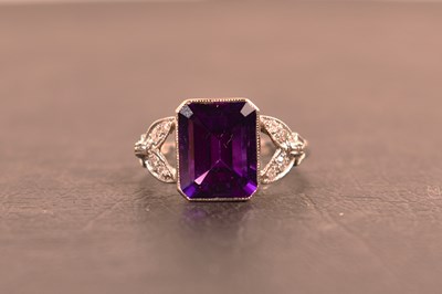 Lot 114 - A platinum, diamond and amethyst ring, the...