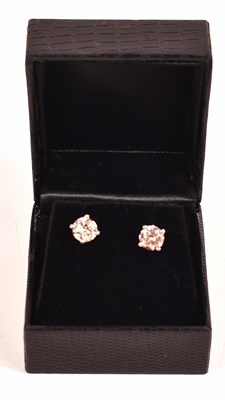 Lot 172 - A pair of platinum and diamond earrings, each...