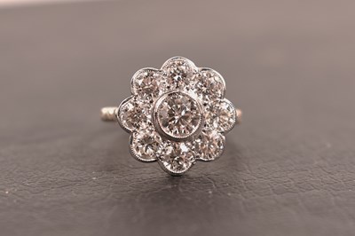 Lot 131 - An 18ct gold, platinum and diamond flowerhead...