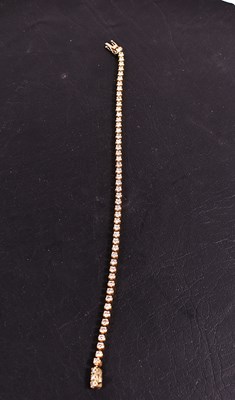 Lot 130 - An 18ct gold and diamond tennis bracelet, with...