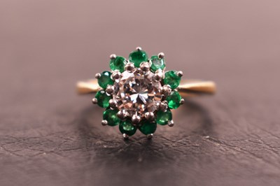 Lot 112 - An 18ct gold, diamond and emerald ring, the...