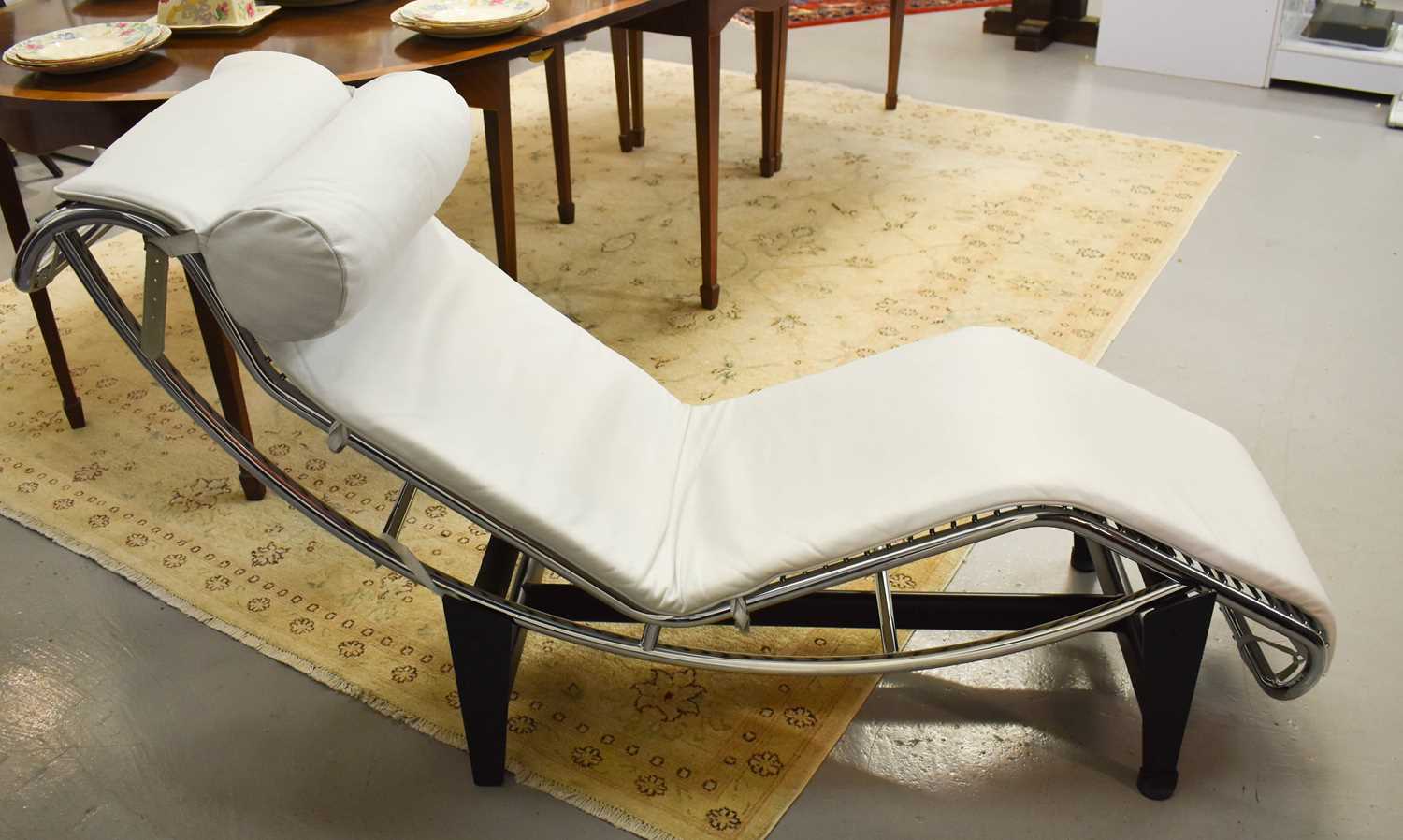 Lot 221 - A Le Corbusier style white leather chaise...